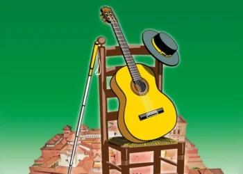 Yellow acoustic guitar resting on a wooden chair with a hat on the backrest and a microphone stand beside it, over a hill of orange rooftops against a green sky.