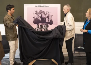 Six people stand in a row as a large black cloth is pulled away to unveil a pink poster in a gallery setting, title ‘EL MUNDO…’ visible behind them, indicating a Flamenco event poster fantasy scene.