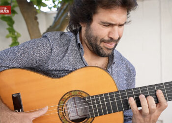 Guitarist outdoors playing a classical guitar, focused on the fretboard; Expo Flamenco logo in the top-left.