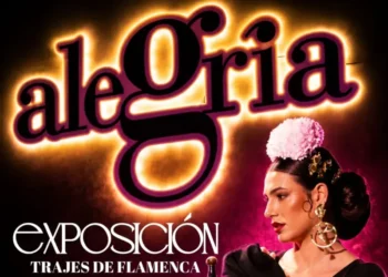 Poster for a flamenco dress exposition; a dancer in black with pink flowers against a neon sign.